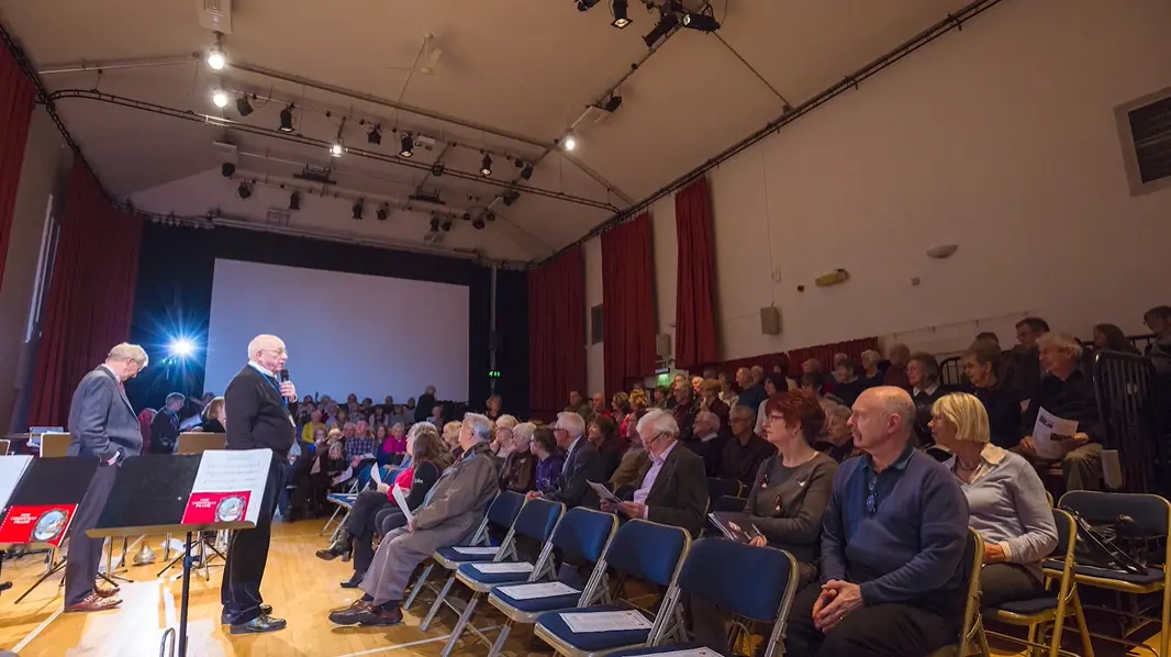 A full audience seated in the Main Hall auditorium during a community presentation or film screening at Parbold Village Hall.