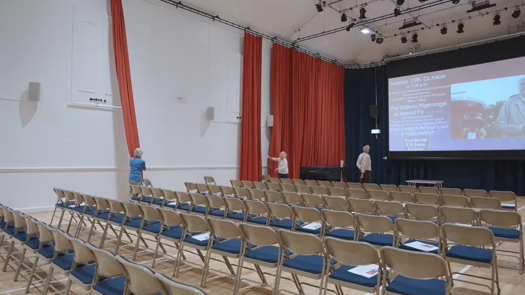 The Main Hall arranged with rows of chairs facing a large cinema screen for a Parbold Picture House film screening.
