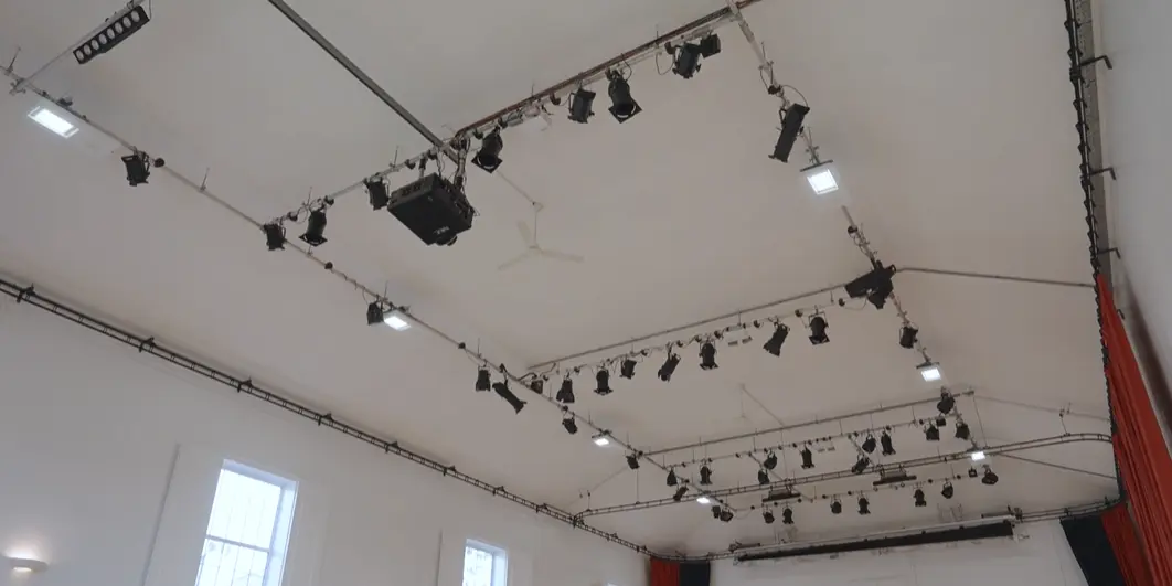 A detailed shot of the high ceiling in the Main Hall, showcasing the professional-grade theatre and event lighting rigs.